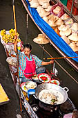 Thailand, Locals sell fruits, food and products at Damnoen Saduak floating market near Bangkok 